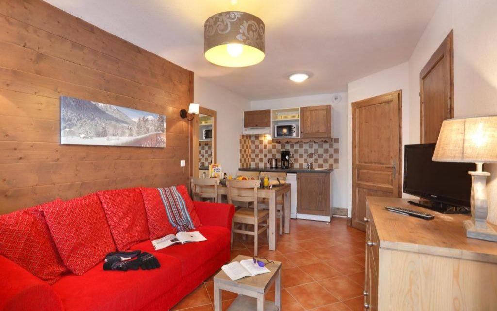 Slide Apartment living room at the Le Grand Lodge residence with sitting area and dining space