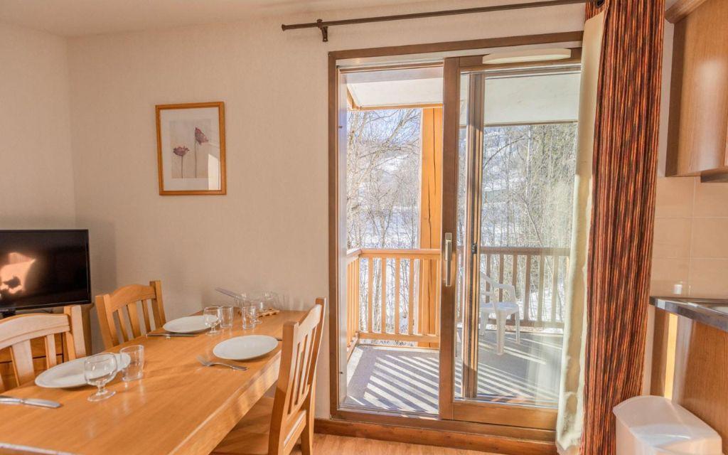 Slide Table à manger avec accès au balcon extérieur pour sur les montagnes depuis la résidence Les Bottières