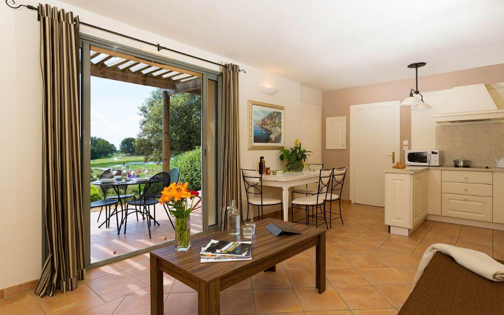 Slide Open-plan living room with lounge and dining area in an accommodation unit at the Provence Country Club residence
