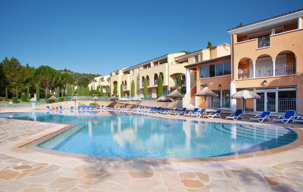 Slide Outdoor swimming pool at La Licorne de Haute Provence residence in Gréoux-les-Bains with sun loungers