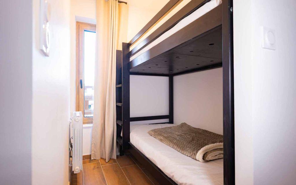 Slide Sleeping area with bunk beds in an apartment at the Arya Living Stone residence