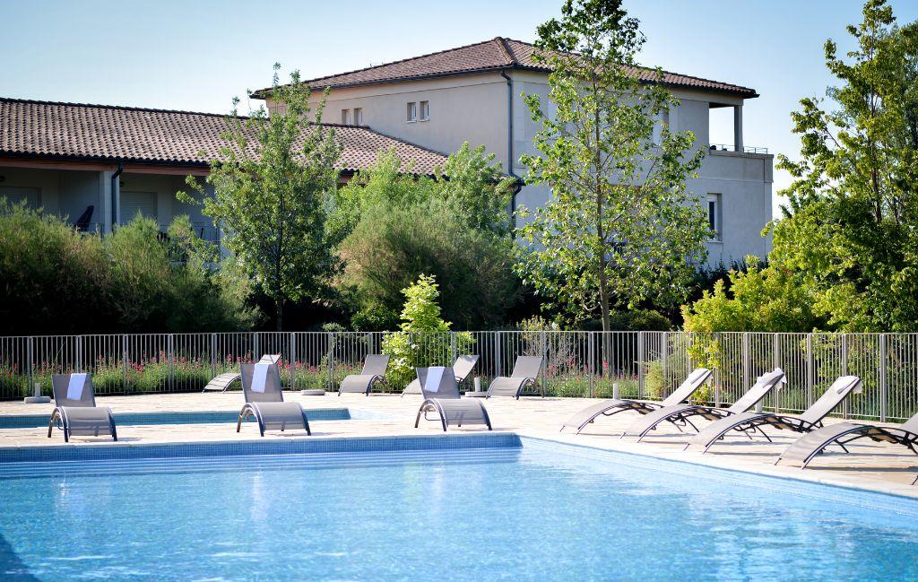 Slide Outdoor swimming pool surrounded by vineyards at the Château de Jouarres residence in Azille