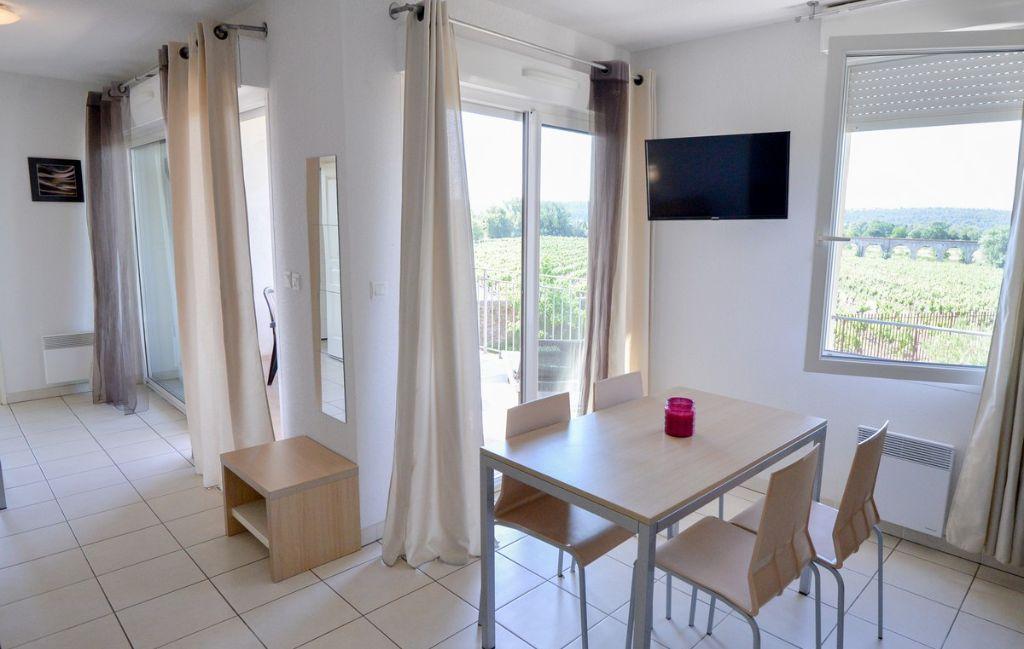 Slide Spacious lounge in the apartments of the Château de Jouarres residence in Azille