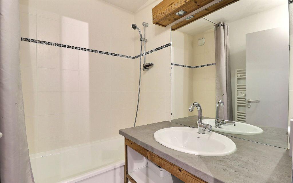 Slide Bathroom with bathtub and cabinet in an apartment in the Grands Bois residence in Courchevel La Tania