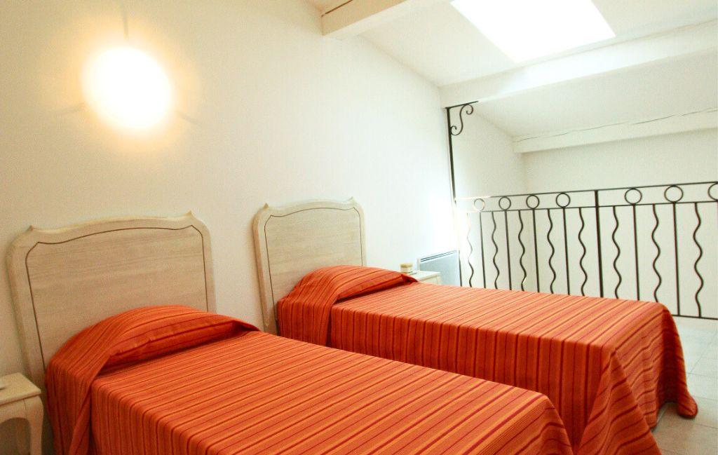 Slide Two single beds in a mezzanine at the Bourgeac estate