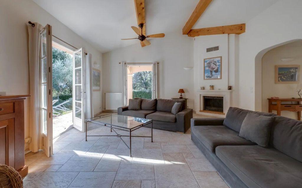 Slide Living room with fireplace opening onto the private terrace of a hamlet house at Domaine de Saint-Endréol Golf & Spa Resort in La Motte-en-Provence