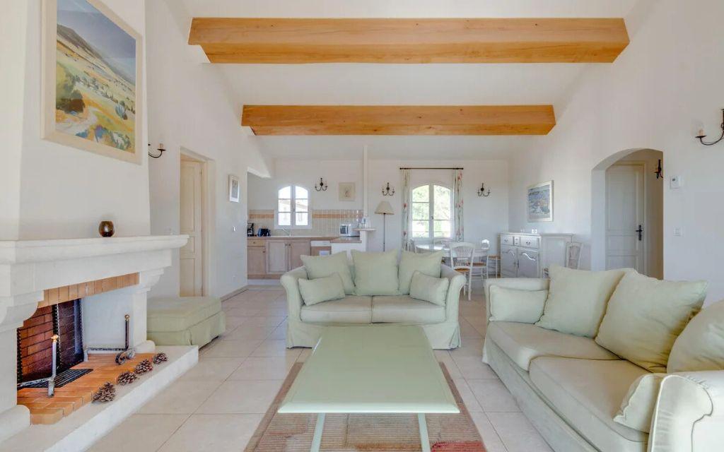 Slide Spacious living room with fireplace in an apartment opening onto a living space at Domaine de Saint-Endréol Golf & Spa Resort in La Motte-en-Provence