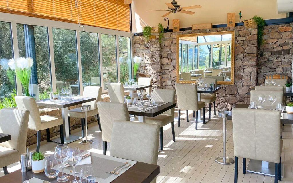 Slide Intimate restaurant with exposed stone decor at Domaine de Saint-Endréol Golf & Spa Resort in La Motte-en-Provence