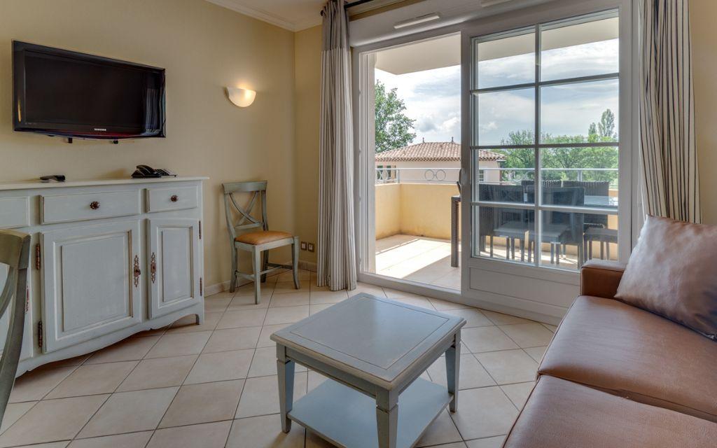 Slide Espace salon avec télévision et accès à une terrasse dans un appartement du Domaine de Camiole
