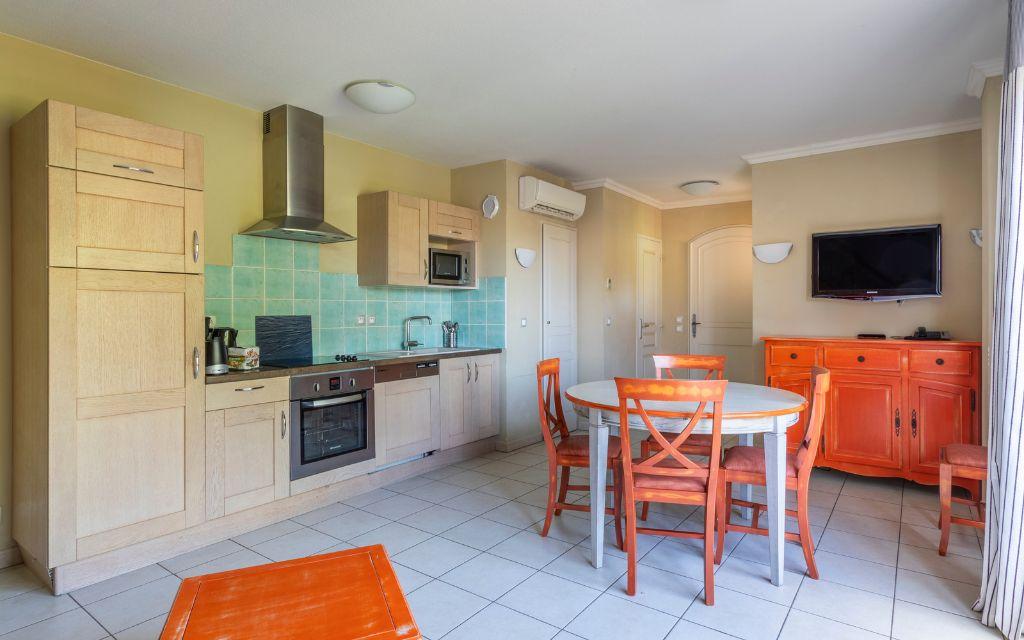 Slide Open kitchen with dining area in an apartment at Domaine de Camiole