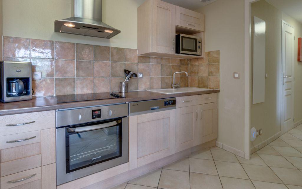 Slide Fully equipped kitchen in a six-person apartment at Domaine de Camiole