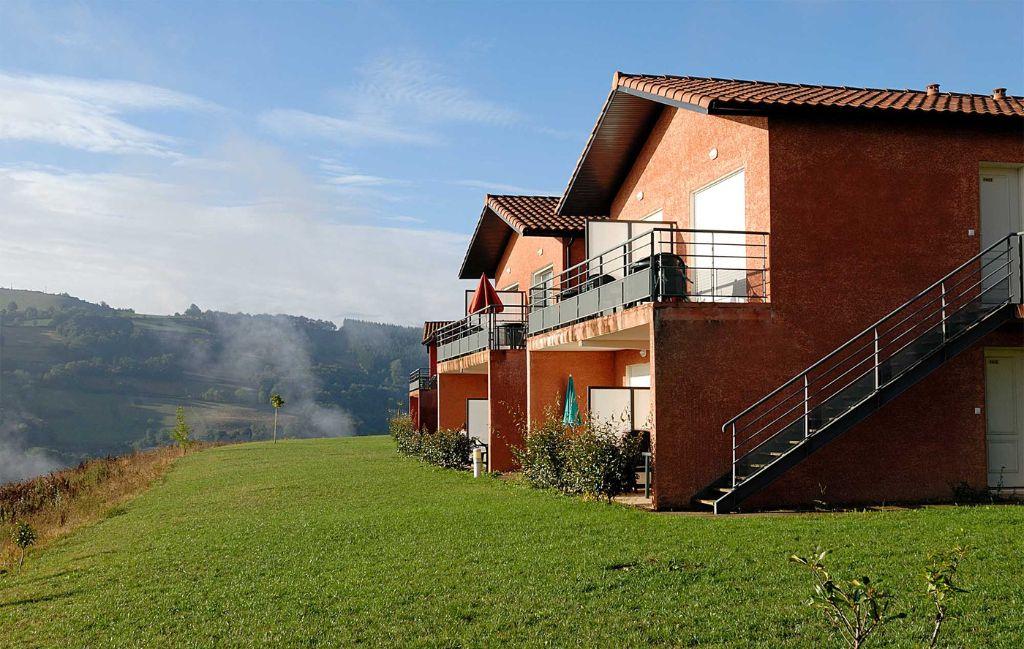 Slide Building façade of the La Marquisié residence overlooking the fields and the Tarn