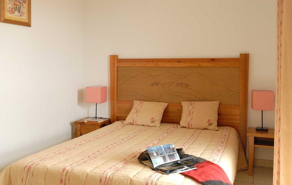 Slide Bedroom with a double bed and bedside tables at La Marquisié