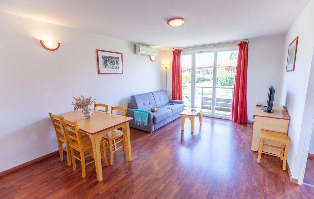 Slide Bright, spacious living room in the apartments at the Hameau de la Chalosse in Cassen