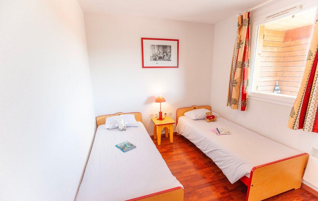 Slide Second bedroom with separate beds in an accommodation at the Hameau de la Chalosse in Cassen