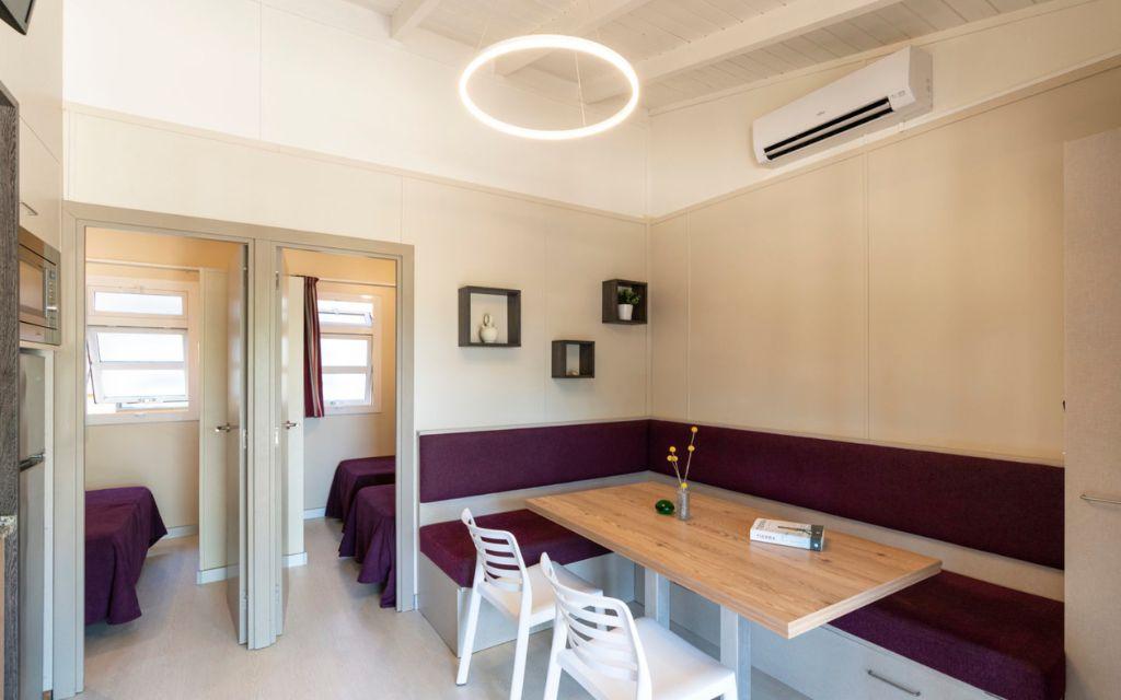 Slide Living room opening onto the two bedrooms that make up the Premium Bungalow at Camping del Mar 4* in Malgrat de Mar