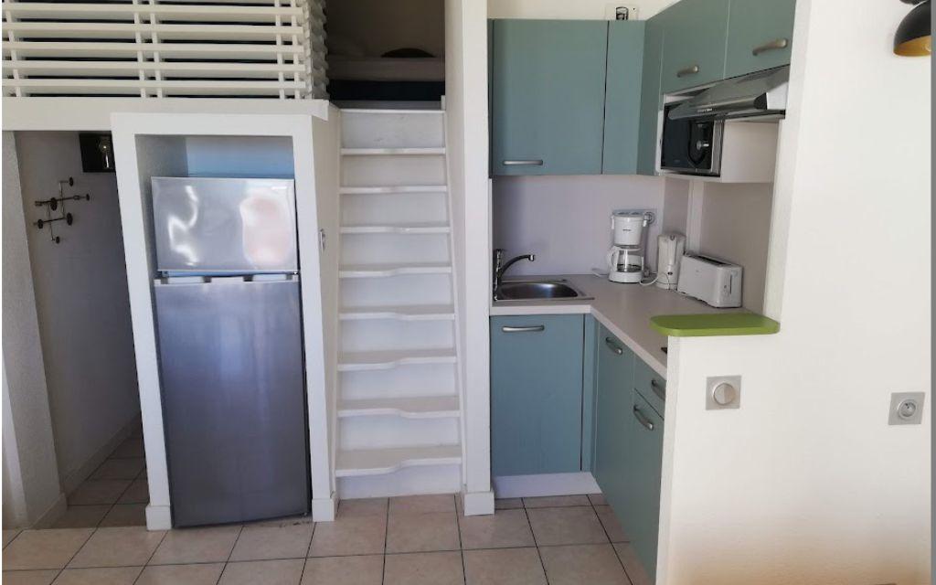 Slide Living area of a studio with a mezzanine and open kitchen at the Eugénie residence in Biarritz