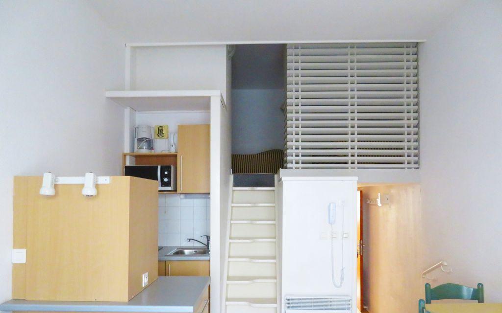 Slide Full living space of a studio for four people at the Eugénie residence in Biarritz, featuring a mezzanine