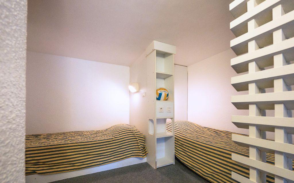 Slide Two single beds in the mezzanine of a four-person studio at the Eugénie residence in Biarritz