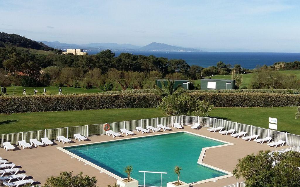 Slide Wide view of the outdoor pool at the Ilbarritz residence with sea view