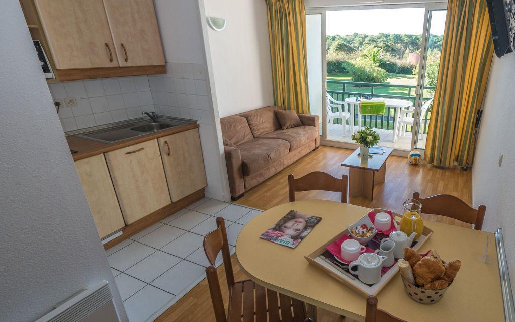 Slide Open-plan living room with dining area in an apartment at the Ilbarritz residence in Bidart