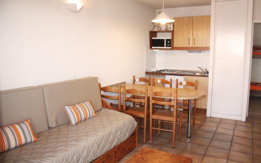 Slide Living room of an apartment at the Soko Eder residence with sofa bed and dining area
