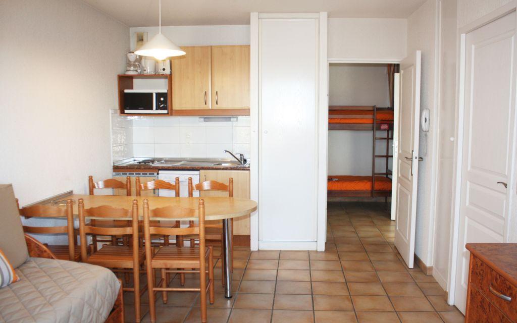 Slide Living area with dining space and a glimpse of the sleeping area in a Soko Eder apartment