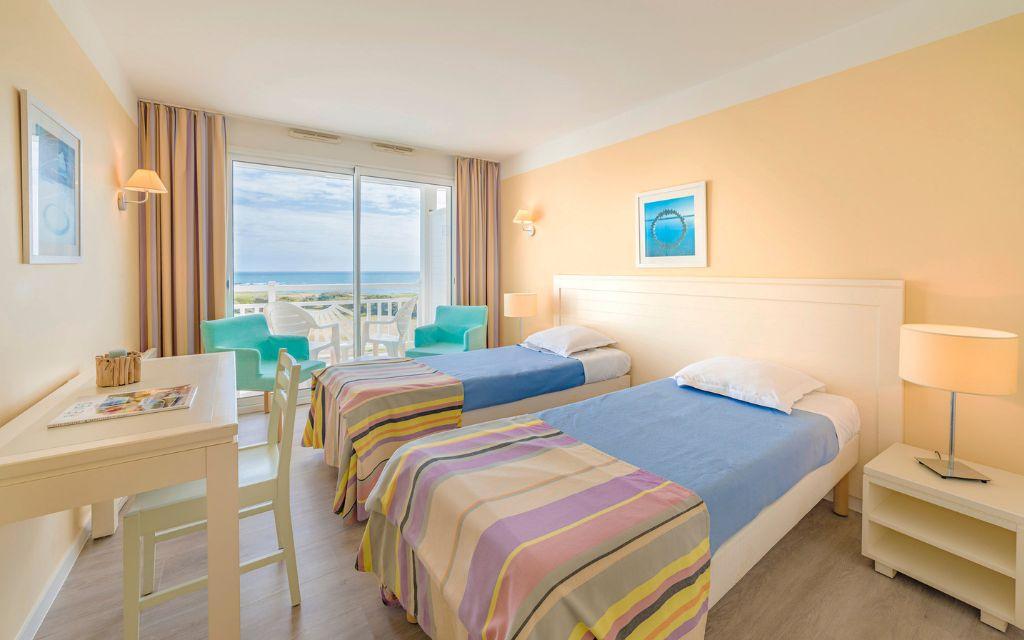 Slide Chambre avec deux lits simples idéale pour une chambre d'enfant donnant un acces au balcon dans un appartement de la résidence l'Estran aux Sables-d'Olonne