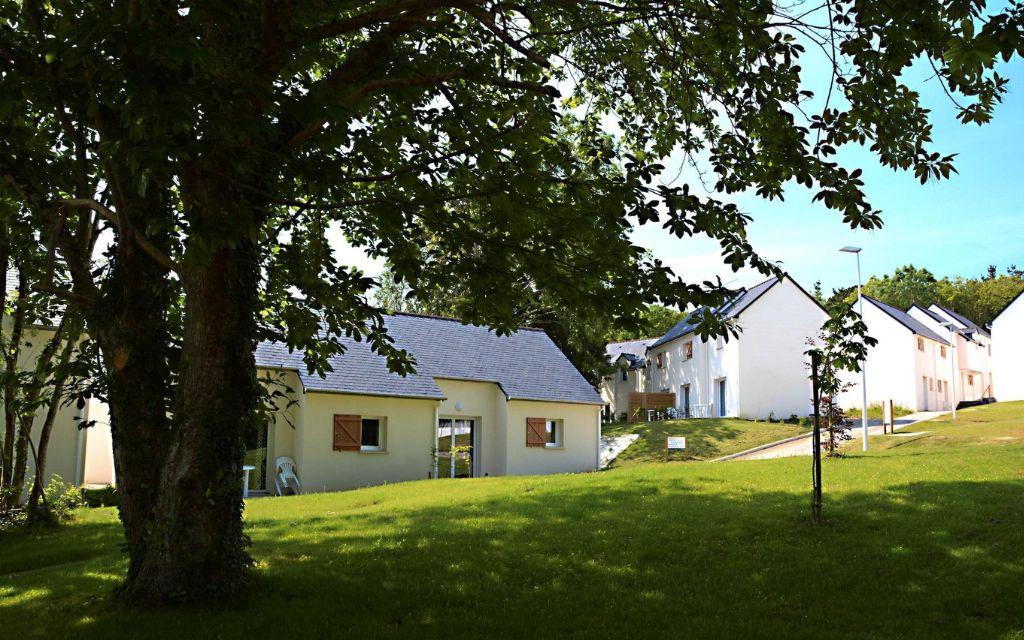 Slide Cottage at the Domaine de la Baie set in a green, landscaped environment