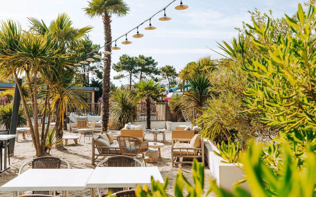 Slide Leisure area arranged around the pool with Mediterranean-style décor at Tropicana Campsite in Saint-Jean-de-Monts, Vendée