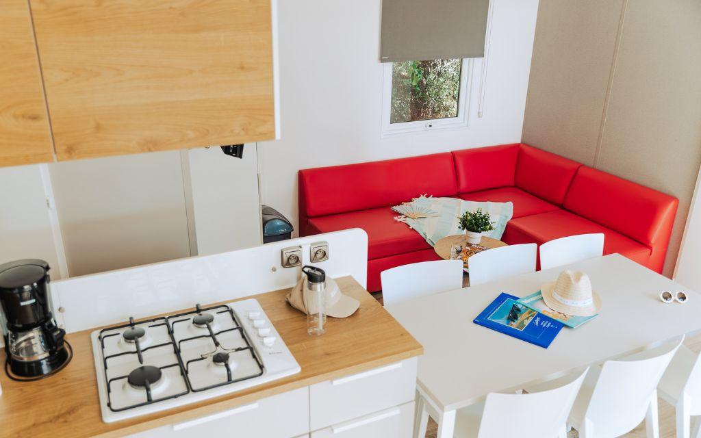 Slide View from the kitchen overlooking the dining and living area in the Premium 6-person cottage at Les Places Dorées***** campsite