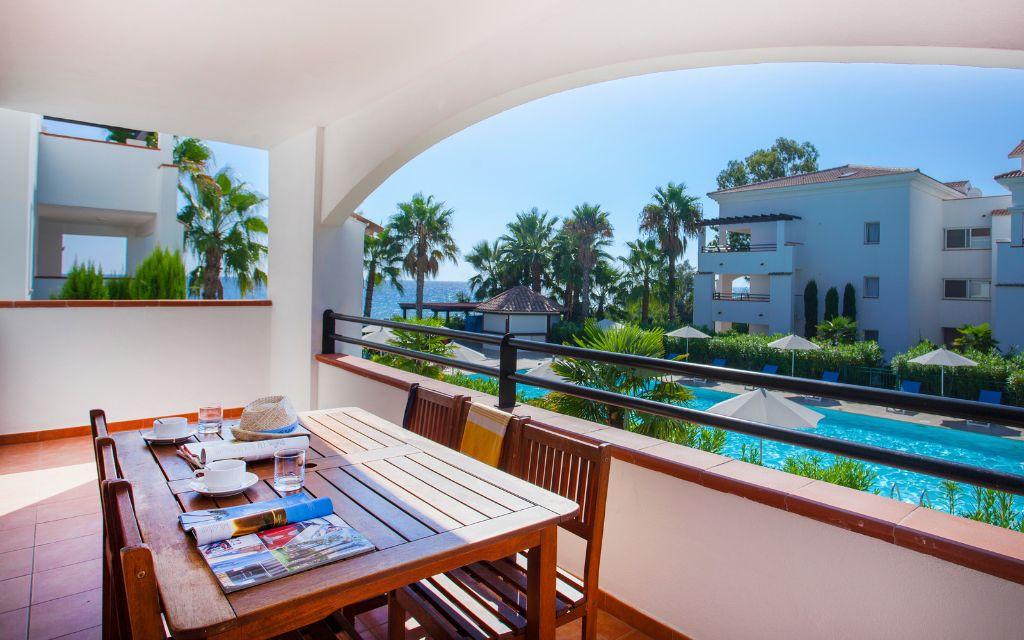 Slide View of the swimming pool and the sea from the balcony of one of the apartments at the Sognu Di Rena residence in Moriani-Plage