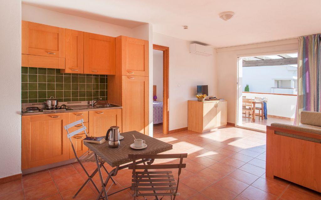 Slide Spacious open-plan kitchen overlooking the living room in one of the apartments at the Sognu Di Rena residence in Moriani-Plage