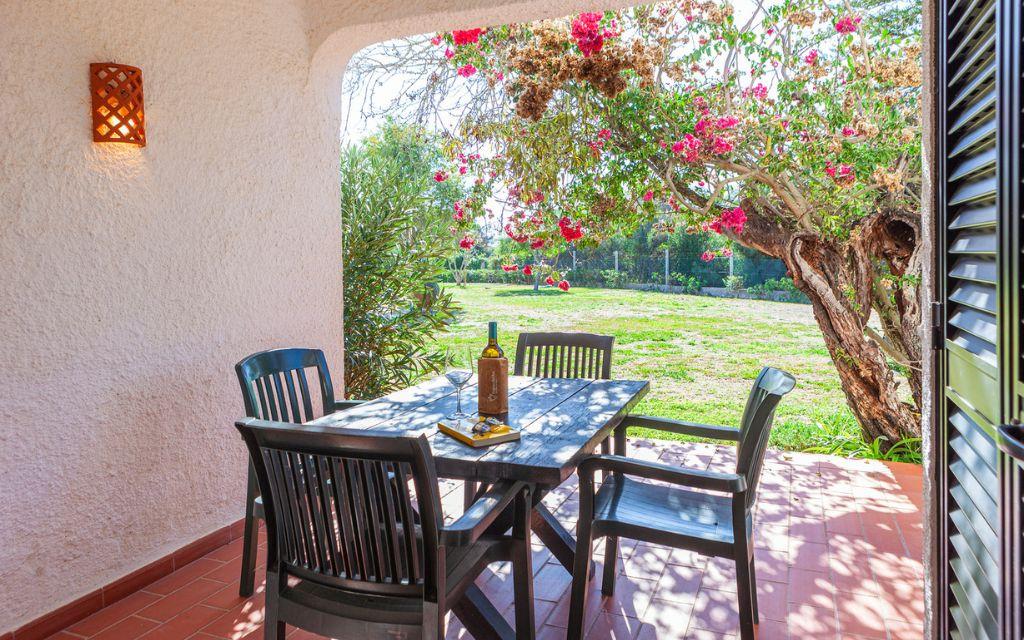 Slide Covered terrace with outdoor lounge furniture in a villa at Pedras da Rainha
