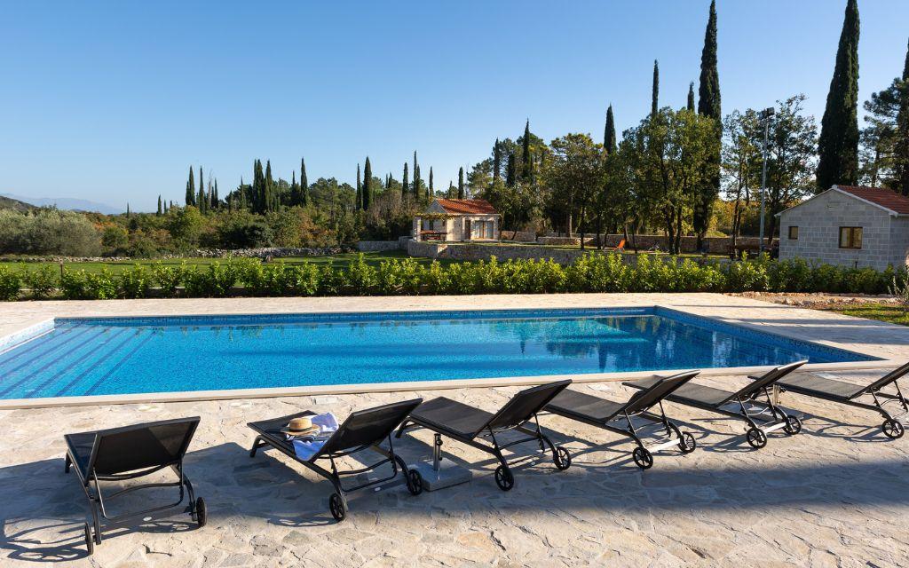 Slide Exclusive properties in Croatia featuring two cottages and a shared 100 m² swimming pool