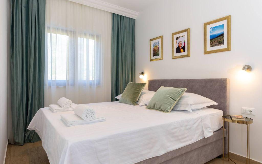 Slide Bedroom with a cosy double bed, comfortable for a couple, at the Sveta Ana Lodges cottages in Croatia