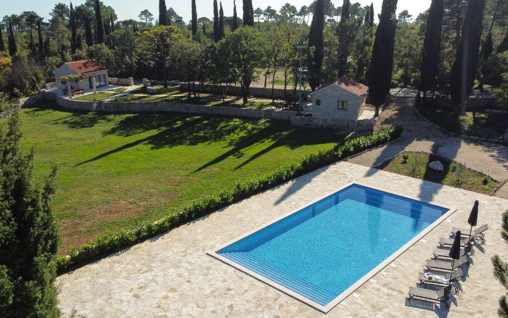 Slide A holiday of complete privacy and tranquillity at the Sveta Ana Lodges cottages, featuring a large swimming pool