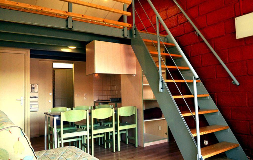 Slide Duplex at Résidence Vorey-sur-Arzon with dining area and staircase leading to the upper floor