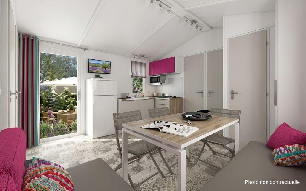 Slide Bermudes mobile home facilities with living area and kitchen at Camping Lacasa in Calcatoggio
