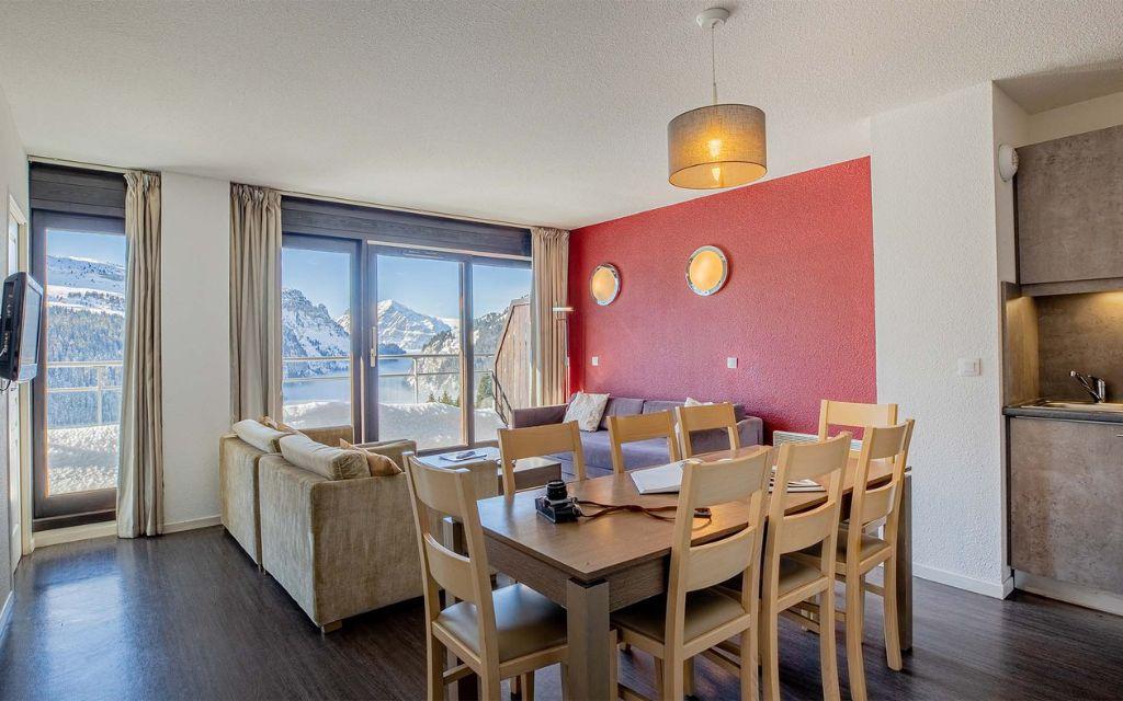 Slide Living area in the spacious apartments with a large picture window at Les Terrasses de Veret Residence in Flaine