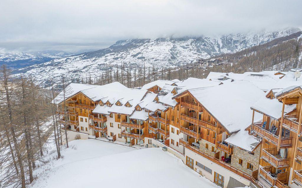Slide Aerial view of Le Parc des Airelles residence covered in snow