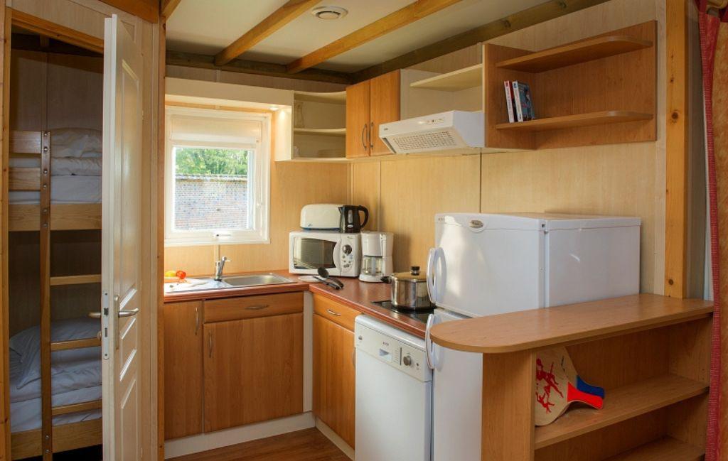 Slide Kitchen area opening onto the bunk bed room in the 6-person chalets at La Ferté-Imbault