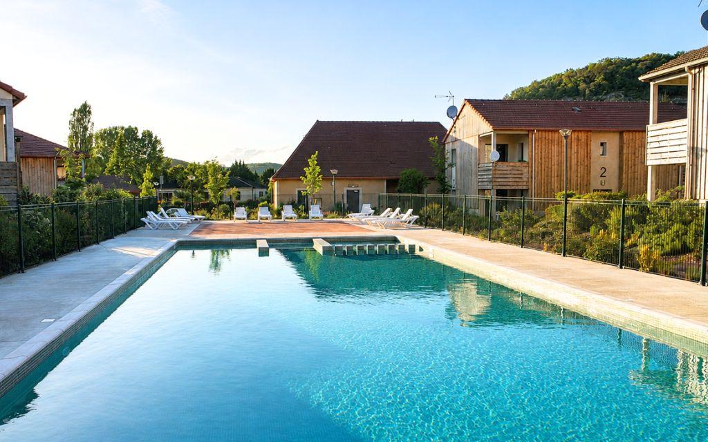 Slide Outdoor pool at Résidence Le Clos du Rocher with sun loungers