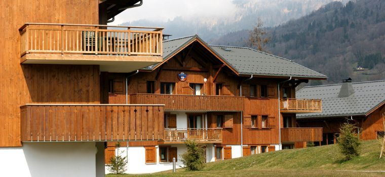 Les Fermes de Samoens residence wooden chalets overview in summer