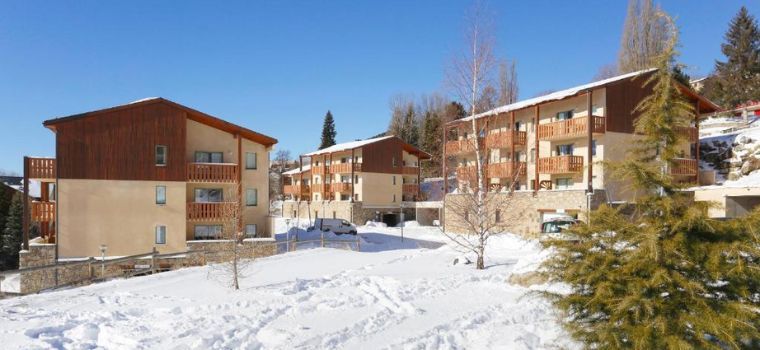 Les Chalets du Belvédère residence under a blanket of snow