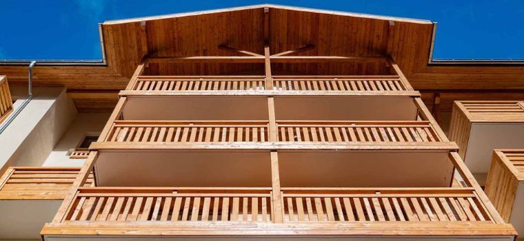 Wooden façade with a beautiful blue sky at the Arya Living Stone residence in Vars