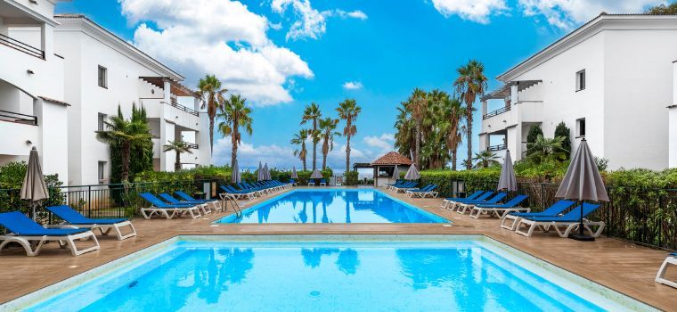 Central outdoor swimming pool with paddling pool at the Sognu Di Rena residence in Moriani-Plage