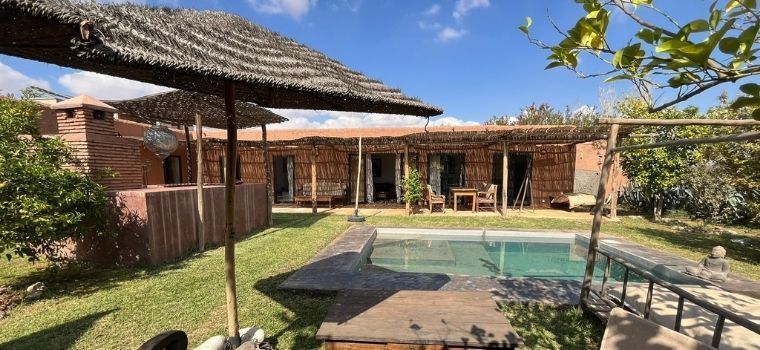 Outdoor area with private swimming pool, enclosed garden, and bar corner at Villa Dar Wellness in Marrakech