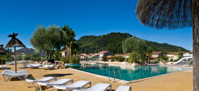 Outdoor water park with bridge at Le Clos des Oliviers residence