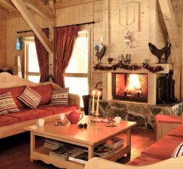 Salon commun chalereux avec cheminée aux Fermes de Samoens en Savoie